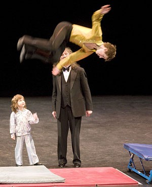 A young performer of the Russian American Kids Circus on Stage somersaults as Alex Berenchtein, one of the troupes founders, looks on. The troupe of young performers, all between the ages of six and 16, gave two shows at Centennial Hall yesterday.
