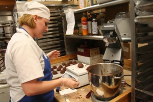 Pastry Captain Amanda Hepler weighs cookie dough before baking at Beyond Bread on North Campbell Avenue. 