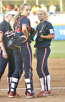 UA catcher Callista Balko, middle, visits pitcher Taryne Mowatt in the circle during the Wildcats 1-0 victory over Tennessee on June 5 in the second game of the Womens College World Series. Balko, a finalist for Homecoming queen, vies for the crown tonight.