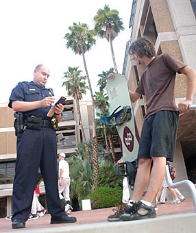 UAPD Officer Mario Leon informs 19-year-old Andrew Reynolds that its unsafe to smowboard on the ILC steps. UAPD is hoping to reduce crime and theft this year by speaking with students at orientation.
