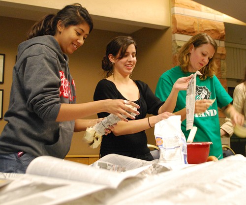 Valentina Martinelli / Arizona Daily Wildcat

From left, Naina Dinesh, a veterinary science and pre business sophomore, and Leila Amini, a bio chemistry and molecular and cellular biology senior, and Karen Johnston a business management junior, make paper mache bones for the art installation 1 million bones event in the SUMC Ventana Room on Wednesday Nov 17. People from all over the United States are making paper mache bones that will be displayed on the Washington DC Mall in the Spring of 2013.