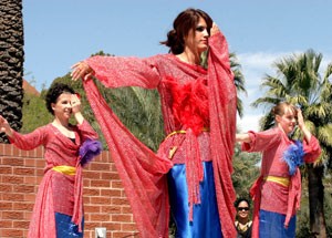 Michelle Ochoa, a business junior, center, dances to an Indonesian music piece yesterday on the UA Mall along with graduate dance student Kris Shaw, left, and Pima Community College foreign language freshman Rebekka Williams, right, as part of the Hands Across Campus diversity fair put on by the University Activities Board.