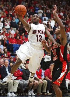 UA sophomore Nic Wise drives for a layup against Oregon State in McKale Center. Wise announced hell return next season to Arizona after thinking about transferring this offseason