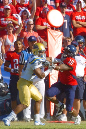 UA wide receiver Mike Thomas (10) gets tied up with a UCLA player in last years 34-27 win at Arizona Stadium. With each team  coming off a loss, both the Wildcats and Bruins are aiming to start their Pacific 10 Conference seasons off with a bang. 