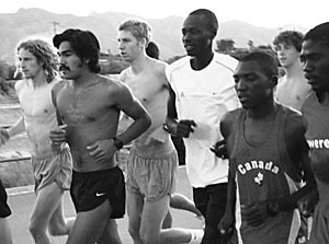 Senior Robert Cheseret, in white, stands above the crowd at the start of yesterdays UA mens cross country practice on the squads practice course. Cheseret will be attempting to win his third straight Pacific 10 Conference cross country Athlete of the Year award this season to round out his collection, which already includes three Pac-10 track and field Athlete of the Year honors.