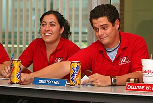Associated Students of the University of Arizona Sen. Bryan Hill presents a Yoo-hoo beverage at last nights senate meeting. Hill is working on making Icecats hockey games more accessible to students.