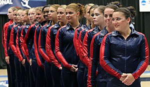 Members of the Arizona gymnastics team stand during the national anthem before NCAA regionals April 14 in McKale Center. After losing to Oregon State at regionals by 0.05 points, the Gymcats did not compete as a team at the NCAA Championships. 