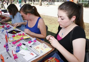 Aubrey Carolyn Wadman-Goetch, a chemistry freshman, creates a square for an awareness quilt alongside Shannon Quay, a public health senior, Wednesday afternoon as part of the LGBTQ Resource Fair held on the UA Mall.