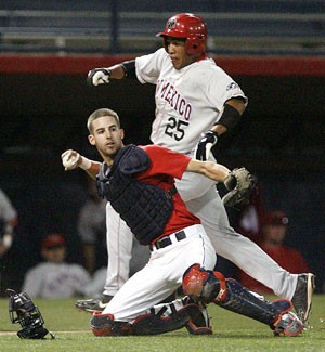 UA catcher Dwight Childs prevents New Mexicos Brian Cavazos-Galvez from scoring by throwing out Coty Wilson at first base after a dropped third strike to end the fourth inning. The Wildcats beat the Lobos 4-1 in last nights game at Sancet Stadium.