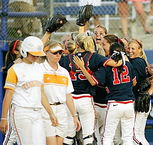 Tennesses Katherine Card, left, and co-head coach Karen Weekly walk across the field as Arizona celebrates its 6-0 win over Tennessee during their Womens College Softball World Series game in Oklahoma City yesterday. Arizona advances to face Northwestern in the championship series starting today at 5.