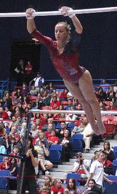 UA redshirt junior Sarah Tomczyk performs her routine on the uneven bars during a dual-meet win against ASU Friday night in McKale Center. The Gymcats have now beaten ASU two straight times and are on a three-match winning streak overall.