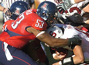 UA defensive end Jason Parker secures a grip on Stanford quarterback Tavita Pritchard during the Wildcats 21-20 loss Saturday at Arizona Stadium. The senior has four sacks on the season, good for second on the team. 