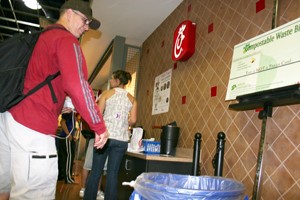 Robert Case, a mechanical engineering senior, makes use of the new compostable waste bin near Chick-fil-A in the Student Union Memorial Center food court Tuesday evening. 