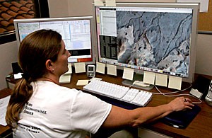 Through her computer, HiRISE operation specialist Audrie Sennema monitors the data of the HiRISE camera for health and safety concerns, such as overheating or power outages.  Sennema also is part of the team that commands the processing of images the camera sends back from space.