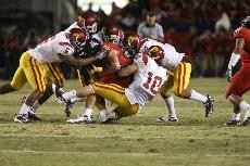 UA tightend Rob Gronkowski is brought down by USC linebacker Brian Cushing (10) and other Trojan defenders during a 17-10 USC win at Arizona Stadium on Saturday night. The loss drops the Wildcats to 5-3 overall and 3-2 in the Pacific-10 Conference heading into their bye week.