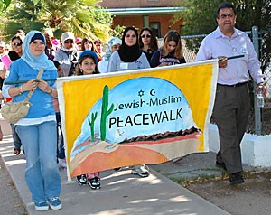 Members of the Jewish and Muslim communities participate in the Peace Walk yesterday afternoon near downtown Tucson.