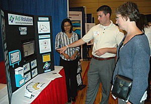 Aaron Ohms, a business administration senior and general manager of AdVolution, explains to Eller Center Director Sherry Hoskinson how location-sensitive advertising works at the fourth annual UA Innovation Day. Innovation Day allows students to show off the research they have been working on.