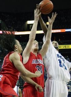 Memphis guard Chris Douglas-Roberts, right, fights for a rebound with UA forward Chase Budinger (34) and guard Daniel Dillon, left, in the first half of the No. 2 Tigers 76-63 win over the No. 17 Wildcats Saturday in Memphis, Tenn. Budinger scored a game-high 20, but the Tigers were out of reach with Arizona missing two starters due to injury and a third in first-half foul trouble.