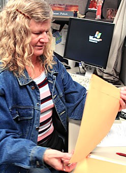 Renee Pollock, an office specialist senior at the payroll office in the University Services building, is responsible for the transfer of UA employee checks. Some departments on campus will implement the new minimum wage increase while others will keep current rates.