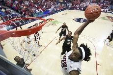 UA forward Jordan Hill leaps for a dunk in the Wildcats 69-56 win over San Diego State on Wednesday night in McKale Center. Hill registered 25 points, 14 rebounds and six blocks - all game highs. 