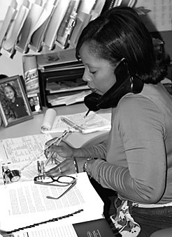 Director of admissions Tanisha Johnson takes calls Friday afternoon in the admissions office for the College of Medicine. Johnson has been especially busy this year with an unusually large number of applicants to the college.