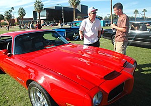 Gary Gorbett, left, shows off his 1973 Firebird to physiology senior Corey Gilchrist during Tau Kappa Epsilons car show on the UA Mall yesterday afternoon. The cars owner, Gorbett said he takes it out only on sunny days. The fraternitys event featured six cars and garnered a total of $1,500, which was donated to the Desert Southwest chapter of the Alzheimers Association. 