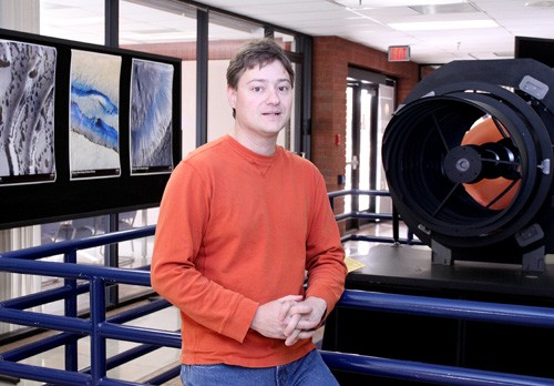 Lisa Beth Earle / Arizona Daily Wildcat

Guy McArthur, HiRISE software developer, stands next to a mock up of the HiRISE, High Resolution Imaging Science Experiment, camera in the Sonnett Space Sciences building. The camera, attached to NASAs Mars Reconnaissance Orbiter, is the most powerful camera ever sent to another planet.