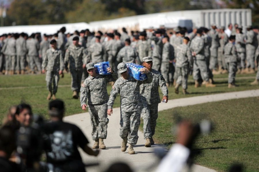 Soldiers bring water onto the field in preparation for the memorial service for victims of the shooting at Fort Hood, Texas, Tuesday, November 10, 2009. 
