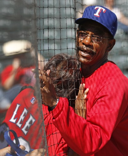 Texas Rangers manager Ron Washington, right, rates a hug from a fan through the net behind home plate prior to action against the Tampa Bay Rays in Game 3 of the American League Division Series at Rangers Ballpark in Arlington, Texas, on Saturday, October  9, 2010. (Ron Jenkins/Fort Worth Star-Telegram/MCT)