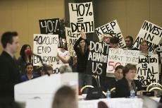 UA students display their opposition to the proposed budget cuts as Michael Slugocki, ASA president, conveys his disapproval of the proposed legislation to the Arizona Board of Regents at the North Ballroom of SUMC, Thursday. Over 900 people attended the meeting.