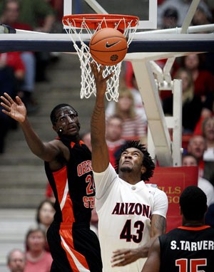 Arizona forward Jordan Hill pulls down a rebound in the Wildcats 76-63 win over Oregon State on Jan. 3 in McKale Center. The Beavers have lost their last 18 games and could become the first winless team in Pac-10 history with two losses this weekend.