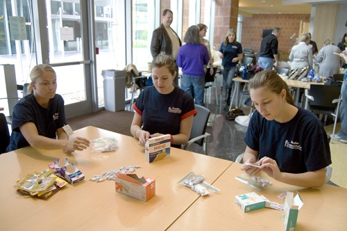 Tim Glass / Arizona Daily Wildcat

(Left to Right) Amy Watts, a communications sophomore, Christine Filer, a communications junior, and Lisa Winston, a communications senior assemble healthcare kits in the BIO5 lobby on Monday, January 18.  The communications club joined with the Tucson IABC to assemble comfort kits for the homeless in an effort to support Operation Deep Freeze.