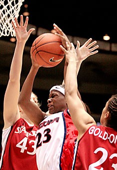 Senior guard Natalie Jones is fouled while powering between two Stanford defenders en route to Arizonas 87-76 loss Saturday in McKale Center. Jones, an Alaska native, tallied 27 points on Senior Day and set a career high in rebounds with 14.
