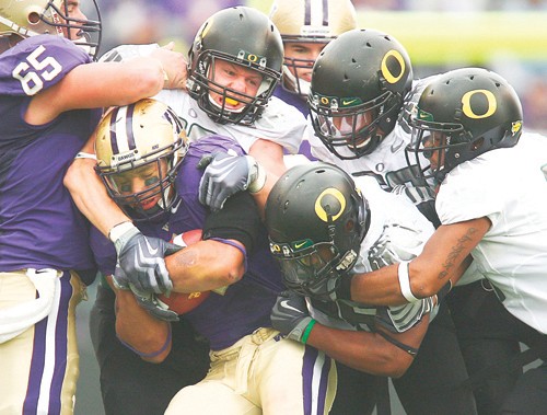 Washington running back Chris Polk is smothered by the Oregon defense in the second half on Saturday, October 24, 2009, at Husky Stadium in Seattle, Washington. Oregon defeated Washington 43-19. (John Lok/Seattle Times/MCT)