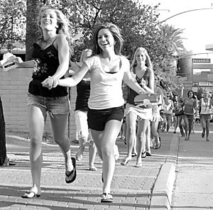 Pre-business freshman Kelly Moore and undeclared freshman Rachel Montgomery ran yesterday afternoon in the traditional Bull Run, which marks the beginning of the pledge semester. Hundreds of greek students welcomed the women with festivities and a barbecue.