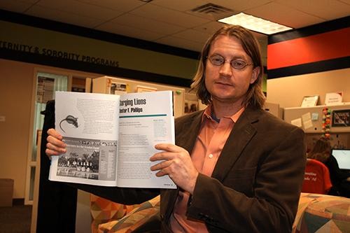 Professor Chester Phillips stands with the current edition of  Creative Nonfiction magazine on Feb. 8, 2011.  Phillips recently won the editor?s prize for a story about animals, according to the UA English department.