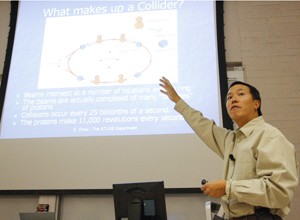 Elliott Cheu, associate dean of the College of Science and member of the Large Hadron Collider-ATLAS team, speaks to a packed auditorium at the PAS building last night. ATLAS, the largest particle accelerator ever built, turned on for the first time yesterday morning.