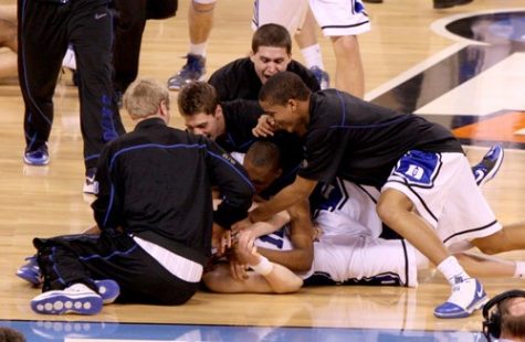 Duke players dogpile on top of Duke's Kyle Singler (12) after Duke's 61-59 victory over Butler in the NCAA Final Four championship game at Lucas Oil Stadium in Indianapolis, Indiana, Monday, April 5, 2010. (Ethan Hyman/Raleigh News & Observer/MCT)