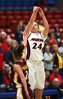 UA guard Malia ONeal attempts what would have been the game-tying shot over ASUs Reagan Pariseau in Arizonas 59-54 loss to the Sun Devils Saturday afternoon in McKale Center. ONeals shot fell short of the basket, dashing any hopes of a comeback.