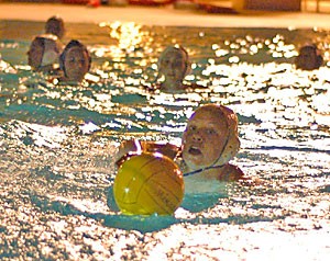 J.J. Hedlund of the Arizonas womens club water polo team holds onto the ball while swimming at the Student Recreation Center in practice Sunday. Hedlund and her team compete in the Southwest Division Championship Saturday and Sunday at the Rec Center. 