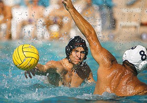 Arizona mens water polo driver Louis Wills, left, launches a ball down the pool during the Wildcats 19-6 win over Old Pueblo Sunday at the Student Recreation Center. The team finished second place in the tournament at the Rec Center and will have its conference championships there Nov. 1-2.