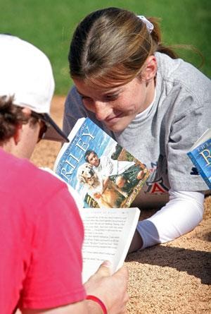 UA outfielder Jon Gaston reads along with Haley OConner, 11. OConner visited the university yesterday with her sixth grade class from Richard B. Wilson Junior High School in Oro Valley to tour the campus.