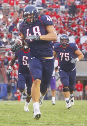 Wildcat tight end Rob Gronkowski races downfield during Arizonas 48-14 win over Washington Saturday night at Arizona Stadium. Gronkowski had three touchdown catches against the Huskies and five scores overall on just eight catches this season.