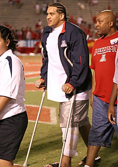 Redshirt senior defensive tackle Paul Philipp walks off the field using crutches after Arizonas 20-3 loss to USC Saturday night at Arizona Stadium. Philipp tore a ligament in his left knee and is likely out for the season. 