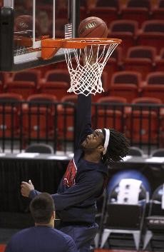 UA forward Jordan Hill leaps for a layup duing practice Thursday evening in AmericanAirlines Arena. Hill and Utah center Luke Nevill should provide an interesting matchup during Fridays game between the No. 12 seed Wildcats and the No. 5 seed Utes.