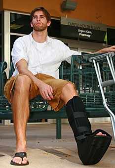 A week after breaking his ankle and receiving the initial treatment, first-year law student Billy Etter waits in the Campus Health courtyard after getting a referral from the sports medicine office. A recent survey by Campus Health and the GPSC shows that graduate students are unhappy that they do not receive prescription, dental or optical benefits. 