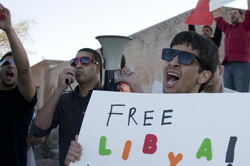 Ginny Polin/ Arizona Daily Wildcat-

During the protest on Tuesday at Speedway and Euclid,  Aman Tekbali, a history and Arabic senior, holds a sign calling for freedom in Libya.  Demonstrators were protesting the recent violent clamp down against unrest in Libya.