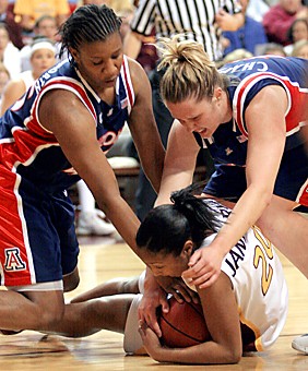 Claire C. Laurence/Arizona Daily Wildcat

Junior forward Joy Hollingsworth, left, and senior center Anna Chappell try to wrestle the ball away from Arizona States Briann January during Saturdays 81-45 loss in Tempe.