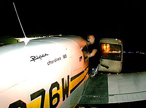 UA Flying Club treasurer Eric Hoffman-Watt pauses as he prepares his Piper Cherokee 160 single-engine plane for a quick flight around Tucson on Friday.