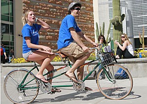 Amanda Peters, a molecular and cellular biology junior and campaign manager for executive vice presidential hopeful Jessica Anderson, rides on a tandem bike with Alex Lichtblau, a biology sophomore and campaigner for ASUA senate hopeful Jared Cohen.